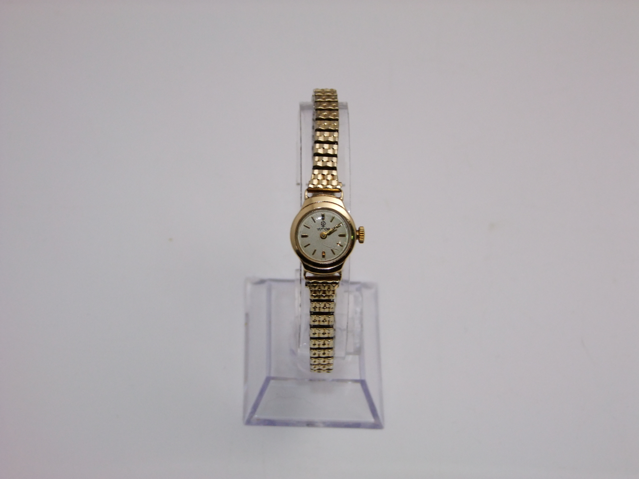 A lady's 9ct gold wristwatch, Tudor Rolex, the circular silvered dial with gilt baton numerals, on a