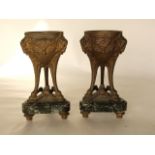 A pair of 19th century cast metal incense burners, with gilded liners, raised on tri- supports