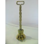 A good quality 19th century brass door stop in the form of a large lions paw with foliate stem and