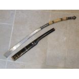 ANTIQUE THAI SWORD WITH SILVER MOUNTED CARVED HILT AND STEEL BLADE IN A BLACK AND GILT LACQUERED