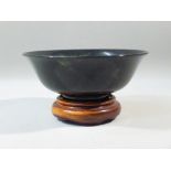 CHINESE DARK GREEN JADE SEMI-TRANSLUCENT CIRCULAR BOWL ON A RAISED CIRCULAR FOOT, ON A STAND (BOWL