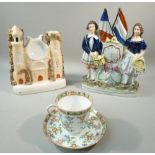 VICTORIAN STAFFORDSHIRE EARTHERNWARE GROUP WITH A SCOTTISH DRUMMER AND HIS LASS FLANKING A CLOCK