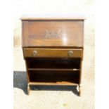 1930's OAK BUREAU WITH A CARVED FALL FRONT, DRAWER AND 2 SHELVES BELOW (101.5 cm x 74 cm x 29 cm)