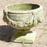 BOWL SHAPED COMPOSITE STONE PLANTER DECORATED WITH SWAGS, ON A FLUTED STEM AND SQUARE BASE (H: 32.