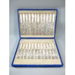 A TWELVE PLACE SETTING OF VICTORIAN DESSERT KNIVES AND FORKS, CHASED FLORAL DECORATION, HAND CARVED