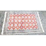 EASTERN MADDER AND IVORY FIELD RUG WITH ALL-OVER STEPPED LOZENGES SURROUNDED BY A MULTIPLE BORDER (