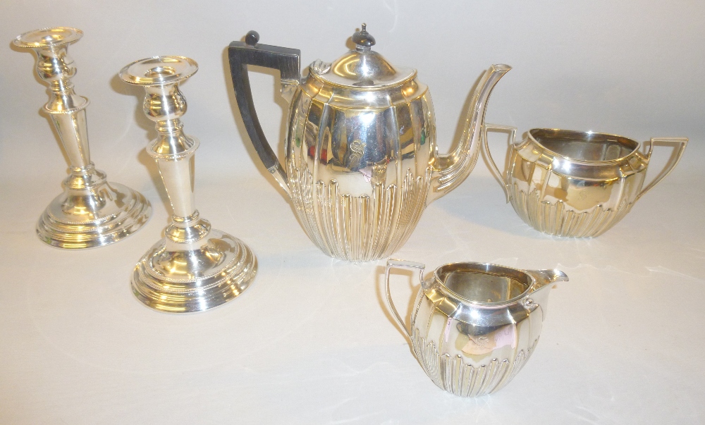 PAIR OF SILVER PLATED CANDLESTICKS, SILVER PLATED TEAPOT, SUGAR BOWL AND JUG ALL WITH 'S' ENGRAVED