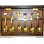 SET OF SIX GEORG JENSEN GILT WHITE METAL AND ENAMEL FLOWER SPOONS FOR 1976 WITH DIFFERENT FLOWER