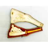 LARGE MEERSCHAUM PIPE DEPICTING A RECLINING GENTLEMAN, WITH AMBER STEM, IN ORIGINAL LEATHER CASE (L: