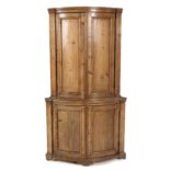 A DUTCH PINE BOWFRONTED CORNER CUPBOARD, 19TH CENTURY the moulded pediment above a plain frieze, a