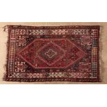 A QASHQAI RUG, SOUTH WEST PERSIA, CIRCA 1960 the madder field with a blue stepped medallion, dark