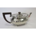 A VICTORIAN SILVER TEAPOT, WILLIAM HUTTON & SONS, LONDON. 1884 the oval compressed body with