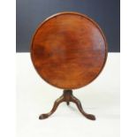 A WILLIAM IV MAHOGANY TILT-TOP PIE CRUST TABLE the circular moulded top above a baluster-shaped