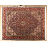 A TABRIZ CARPET, NORTH WEST PERSIA, MODERN the dark blue field with a bold red and ivory