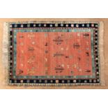 A FLATWEAVE KELIM CARPET, PERSIA, MODERN the pale red field with scattered floral devices and