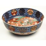 A LARGE JAPANESE IMARI BOWL, MEIJI, 1868-1912 the interior painted with a phoenix and dragon amongst