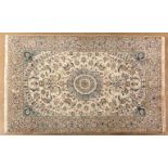 A NAIN CARPET, PERSIA, MODERN the ivory field with a pale blue floral star medallion, similar