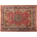 A MESHED CARPET, EAST PERSIA, MODERN the red field with a bold indigo-blue floral star medallion and