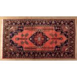 A HAMADAN RUG, PERSIA, MODERN the red field with a bold blue and red diamond medallion, similar