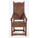 A DUTCH OAK ARMCHAIR, 18TH CENTURY the hard panelled back between curved arms on square-section