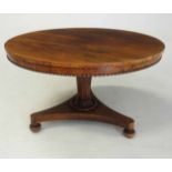 A VICTORIAN ROSEWOOD TILT-TOP CENTRE TABLE the circular top above a plain frieze with an egg-and-