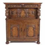 AN ENGLISH OAK MARQUETRY AND INLAID COURT CUPBOARD in two parts, the outswept cornice above a