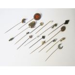 A MISCELLANEOUS GROUP OF SIXTEEN STICK PINS of various designs, including a claw grasping an old-cut