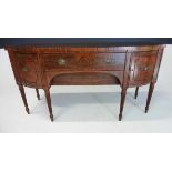 A REGENCY FLAME MAHOGANY SIDEBOARD the bowfronted top above a central frieze drawer flanked by