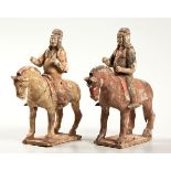 A PAIR OF CHINESE PAINTED RED POTTERY FIRGURES OF EQUESTRIANS, TANG DYNASTY, 618-906AD each horse,