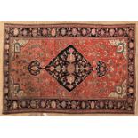 A FINE SAROUK RUG, PERSIA, CIRCA 1900 the madder-red field with a black floral diamond medallion and