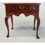 A GEORGE III STYLE WALNUT AND CROSSBANDED LOWBOY the rectangular moulded top above a central