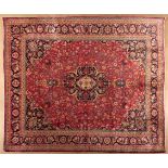 A MESHED CARPET, EAST PERSIA, MODERN the red field with a dark blue floral medallion, similar