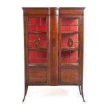 AN EDWARDIAN MAHOGANY AND INLAID DISPLAY CABINET the shaped cornice above a trailing bellflower