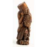 A CHINESE CARVED BAMBOO FIGURE OF AN IMMORATAL, 19TH CENTURY standing on a cloud base, scratching