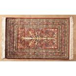 AN INDO-PERSIAN SILK RUG, EGYPT, MODERN the madder-red field with an ascending multicoloured