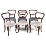 A SET OF SIX VICTORIAN WALNUT BALLOON-BACK CHAIRS each curved top rail above a carved pierced and