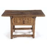 A SPANISH OAK TABLE, 18TH CENTURY the rectangular top above a geometrically carved frieze drawer, on