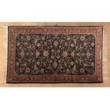 AN ISPAHAN RUG, PERSIA, MODERN the deep indigo-blue field with bold scrolling arabesques with