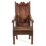 A DUTCH OAK ARMCHAIR, 18TH CENTURY the hard back and seat between curved arms on turned supports,