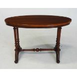 A VICTORIAN MAHOGANY STRETCHER TABLE the shaped oval top above a plain frieze, on four turned fluted