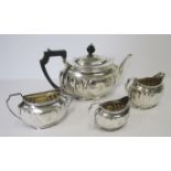 A FOUR-PIECE SILVER TEA SET, ATKIN BROTHERS, SHEFFIELD, 1907 AND 1913 comprising: a teapot, a milk