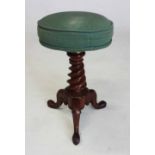 A WILLIAM IV MAHOGANY PIANO STOOL the circular revolving padded seat on a tapering spiral support,