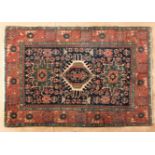 A KARADJA RUG, NORTH WEST PERSIA, CIRCA 1920 the deep indigo-blue field with three Karadja