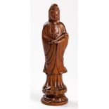 A CHINESE CARVED BOXWOOD FIGURE OF GUANYIN, 19TH CENTURY standing on a double lotus base, holding