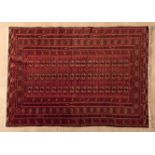 A TURKOMAN RUG, AFGHANISTAN, MODERN the red field with three rows of guls and side guls depicted