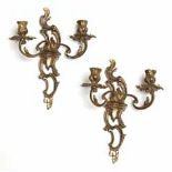 A PAIR OF FRENCH BRASS TWO-LIGHT WALL SCONCES each with a foliate and scrolling mount above two