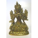 A SMALL SINO-TIBETAN BRONZE FIGURE OF TARA seated in dhyanasana on a lotus base, her right hand in