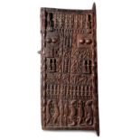 A DOGON GRANARY DOOR, MALI the rectangular door carved with figures, geometric patterns and