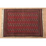 A PAKISTANI RUG, MODERN the red field with four rows of fourteen guls depicted in ivory, orange