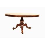A VICTORIAN WALNUT LOO TABLE the shaped oval top above a plain frieze, a central gadrooned support